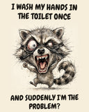 Raccoon watercolor art print with the saying "I WASH MY HANDS IN THE TOILET ONCE AND SUDDENLY I'M THE PROBLEM?"
