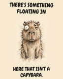 Capybara watercolor art print with the saying "THERE'S SOMETHING FLOATING IN HERE THAT ISN'T A CAPYBARA."