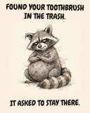 Raccoon watercolor art print with the saying "FOUND YOUR TOOTHBRUSH IN THE TRASH. IT ASKED TO STAY THERE."