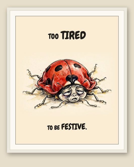 Ladybug watercolor art print with the saying "TOO TIRED TO BE FESTIVE." shown framed with a cream mat — frame for display only, not included