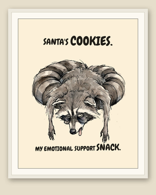 Raccoon watercolor art print with the saying "SANTA'S COOKIES. MY EMOTIONAL SUPPORT SNACK." shown framed with a cream mat — frame for display only, not included