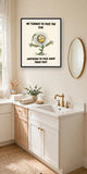 The same print shown hanging in a bathroom — frame for display only, not included