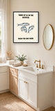 The same print shown hanging in a bathroom — frame for display only, not included