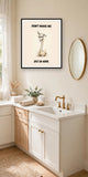 The same print shown hanging in a bathroom — frame for display only, not included