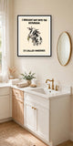 The same print shown hanging in a bathroom — frame for display only, not included