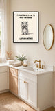 The same print shown hanging in a bathroom — frame for display only, not included