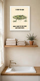 The same print shown hanging in a bathroom — frame for display only, not included