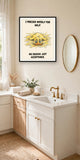The same print shown hanging in a bathroom — frame for display only, not included