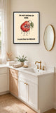 The same print shown hanging in a bathroom — frame for display only, not included