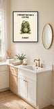 The same print shown hanging in a bathroom — frame for display only, not included