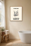 The same print shown hanging in a bathroom — frame for display only, not included