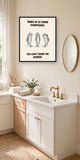 The same print shown hanging in a bathroom — frame for display only, not included