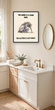 The same print shown hanging in a bathroom — frame for display only, not included
