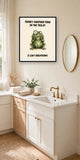 The same print shown hanging in a bathroom — frame for display only, not included