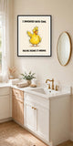 The same print shown hanging in a bathroom — frame for display only, not included