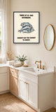 The same print shown hanging in a bathroom — frame for display only, not included