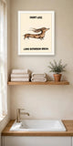 The same print shown hanging in a bathroom — frame for display only, not included