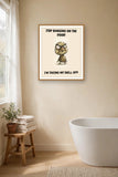 The same print shown hanging in a bathroom — frame for display only, not included
