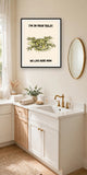 The same print shown hanging in a bathroom — frame for display only, not included