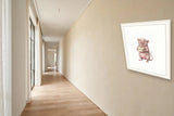 The same wordless print shown hanging on a wall — frame for display only, not included
