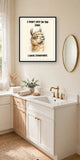 The same print shown hanging in a bathroom — frame for display only, not included