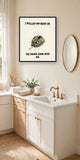 The same print shown hanging in a bathroom — frame for display only, not included