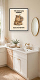 The same print shown hanging in a bathroom — frame for display only, not included