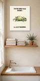 The same print shown hanging in a bathroom — frame for display only, not included