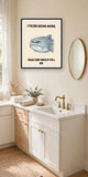 The same print shown hanging in a bathroom — frame for display only, not included