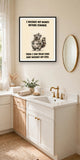The same print shown hanging in a bathroom — frame for display only, not included