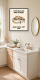 The same print shown hanging in a bathroom — frame for display only, not included