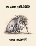 Watercolor illustration of a slumped gray unicorn sitting with its head bowed, messy mane falling over its face and its long twisted horn drooping to the ground, on warm cream. Text above and below reads 'MY MAGIC IS CLOSED FOR THE HOLIDAYS.'